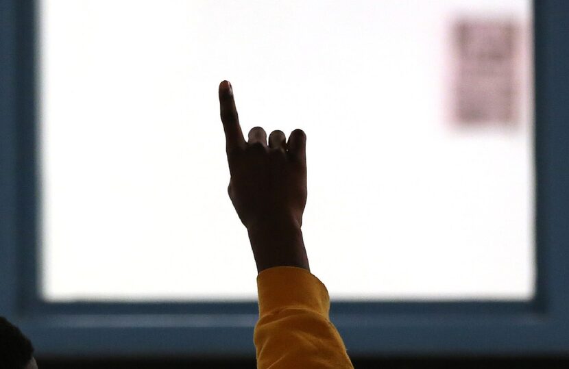 A juvenile offender raises his hand to ask a question during a group session, as seen during...