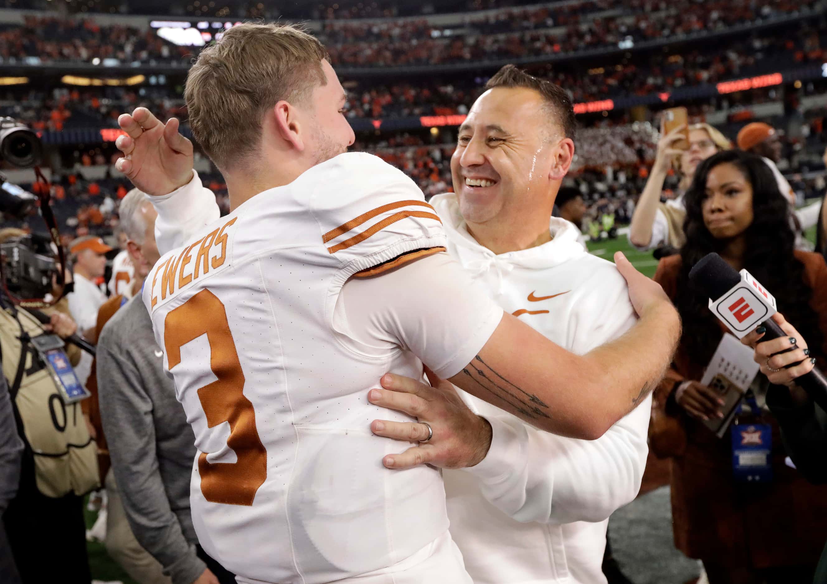 Texas Longhorns head coach Steve Sarkisian hugs his quarterback Quinn Ewers (3) following...