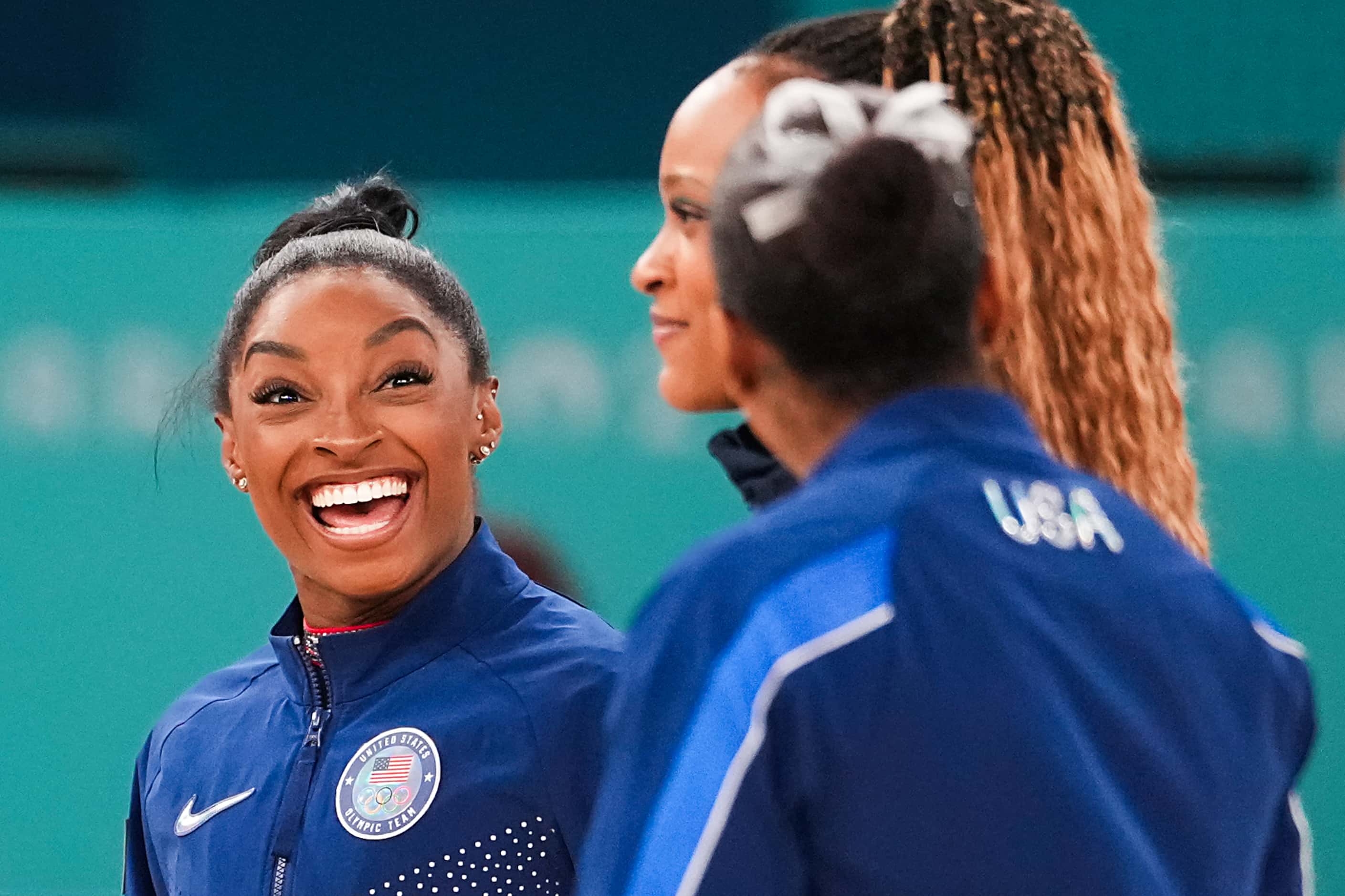 Silver medalist Simone Biles of the United States (left) laughs with bonze medalist Jordan...