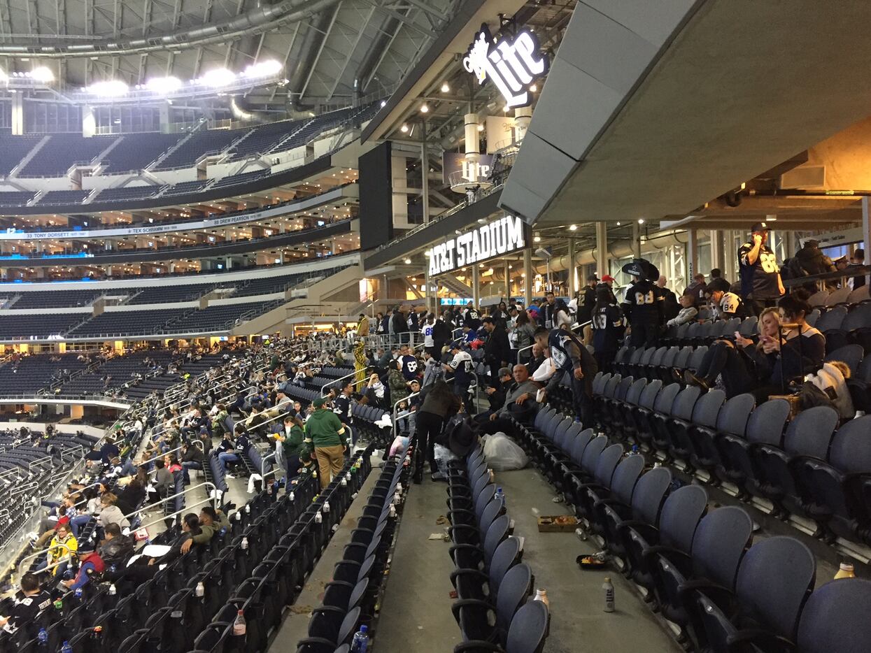 Fans take shelter at AT&T Stadium as a tornado warning is issued in Arlington after Sunday's...