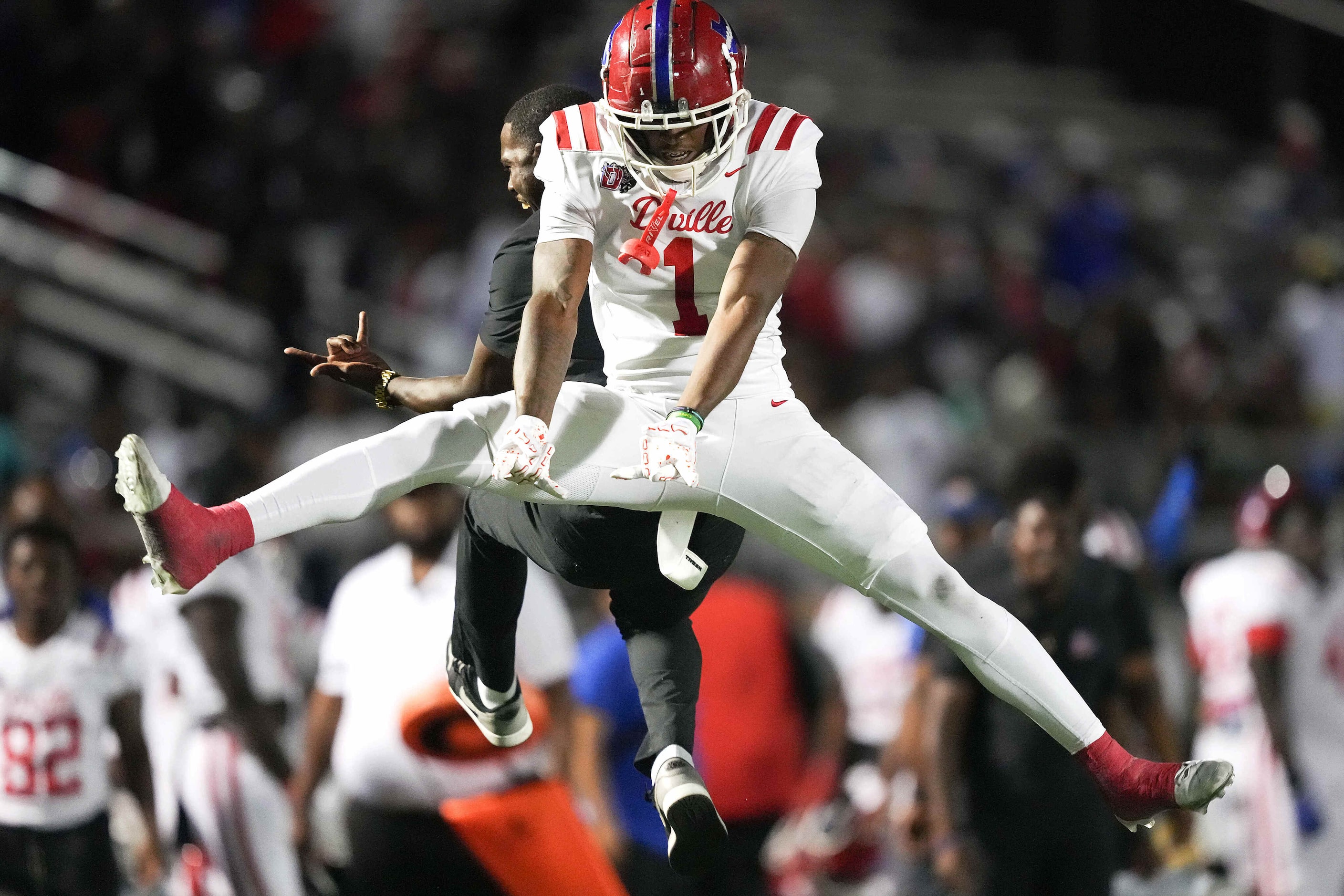 Duncanville wide receiver Dakorien Moore (1) celebrates after scoring on a 43-yard touchdown...