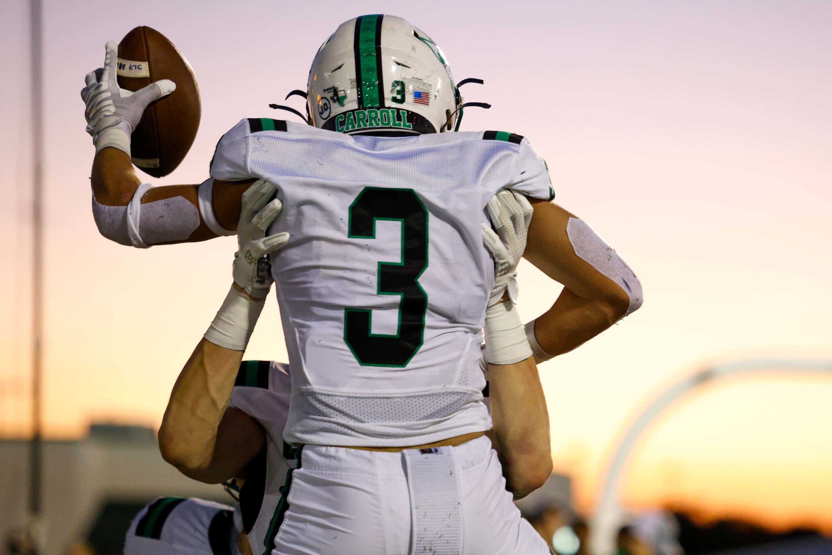 Southlake Carroll running back Davis Penn (3) is lifted into the air by a teammate after...