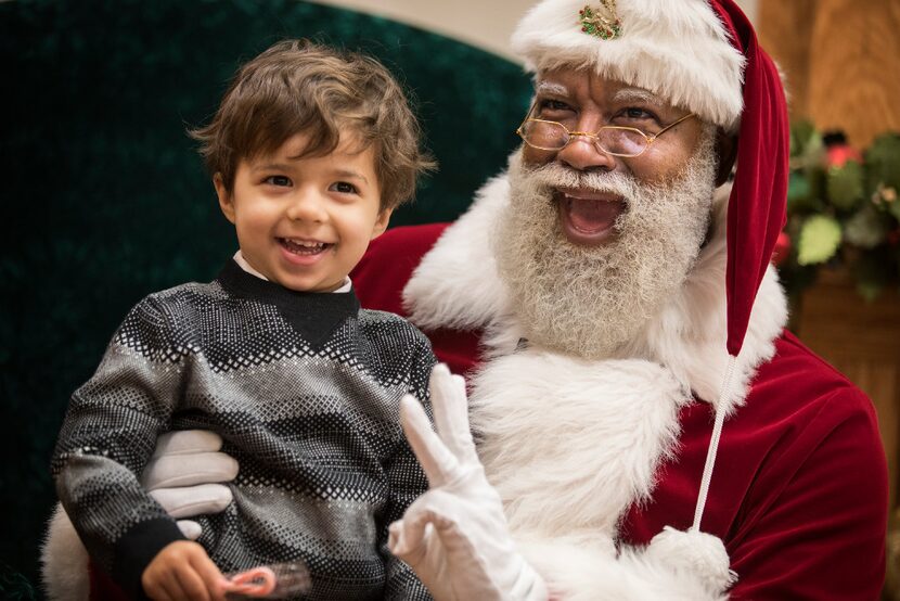 Larry Jefferson (a.k.a. Santa) brings a smile to the face of this little shaver in...