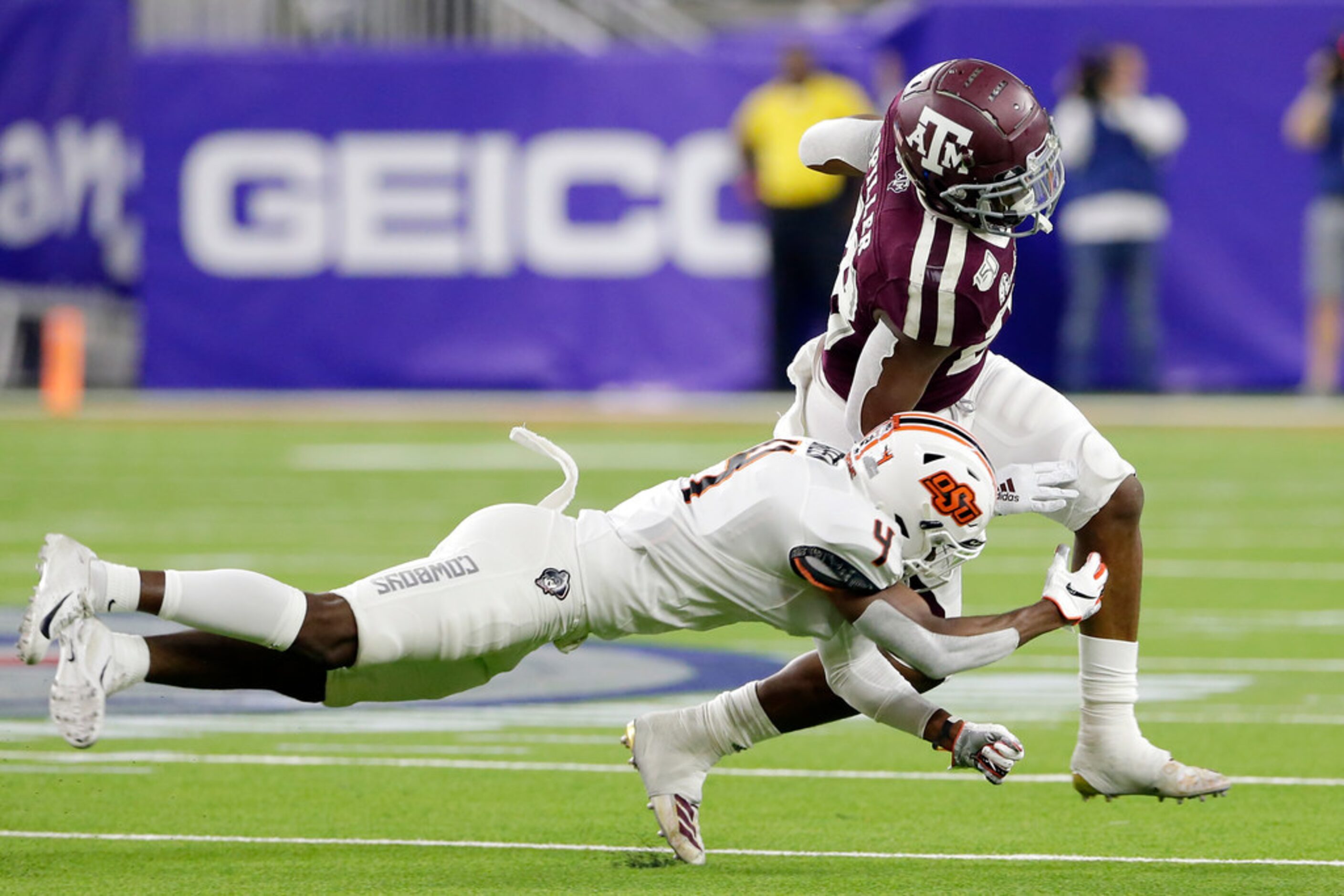 Oklahoma State cornerback A.J. Green (4) dives to tackle Texas A&M running back Isaiah...