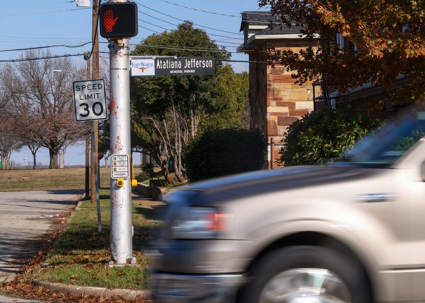 A car moves along the stretch of roadway dedicated in memory of Atatiana Jefferson in Fort...