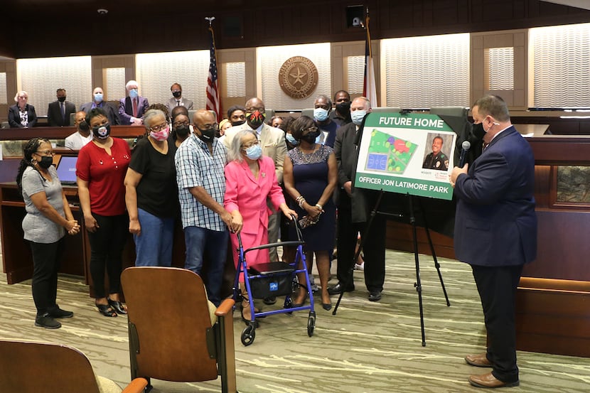 Mayor Bruce Archer presents plans for Jon Latimore park to the late police officer's family...
