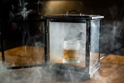 Beverage director Alex Fletcher created a cigar-smoked Old-Fashioned cocktail, which diners...