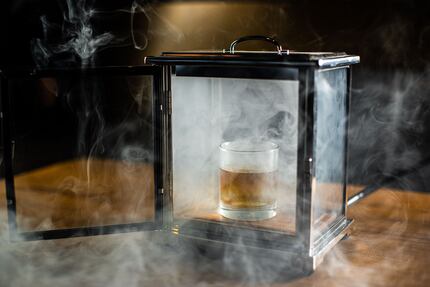 Beverage director Alex Fletcher created a cigar-smoked Old-Fashioned cocktail, which diners...