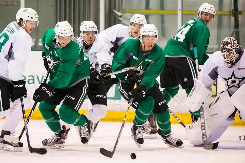 (From left to right) defenseman Niklas Hansson (38), defenseman Michael Prapavessis (51),...