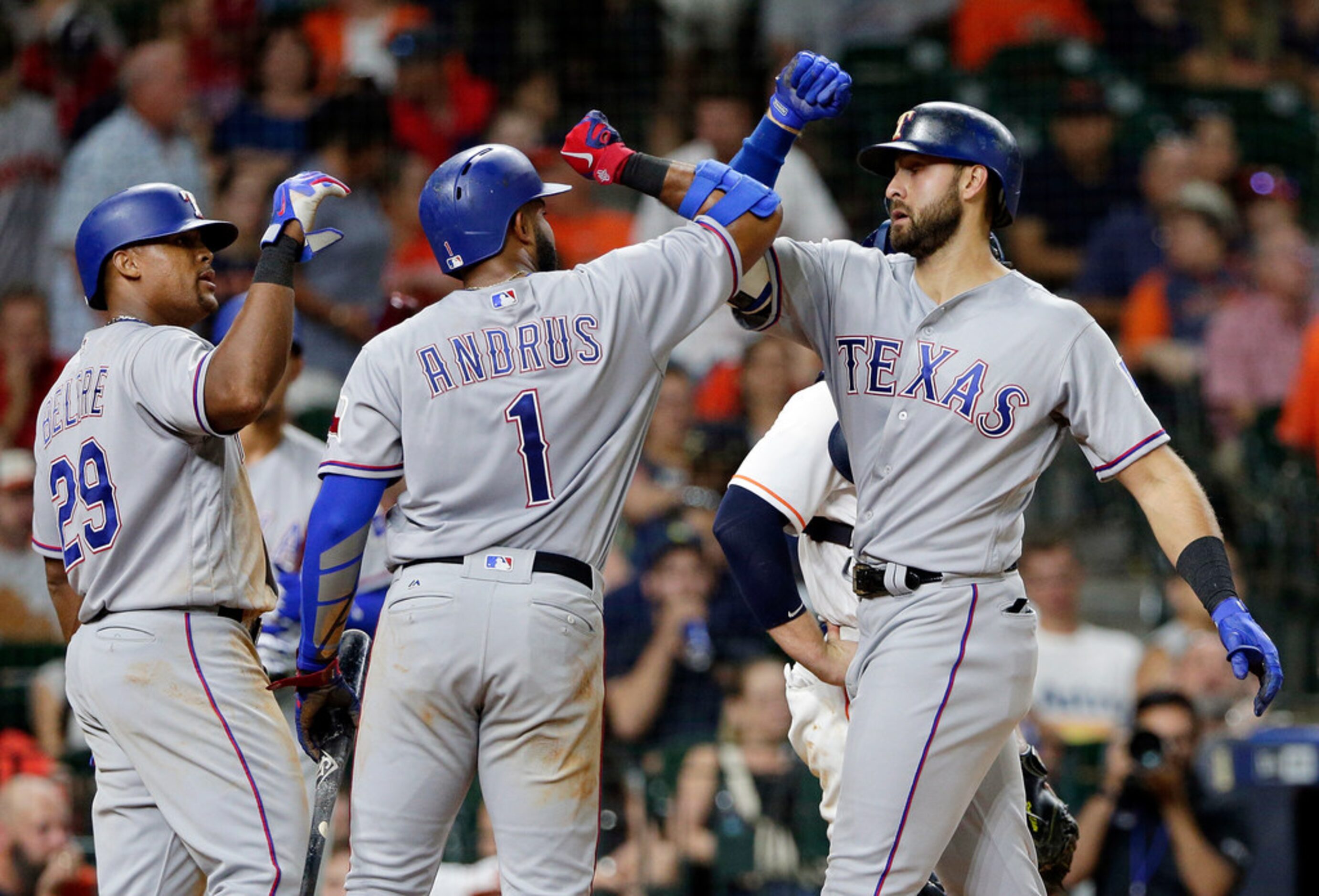 Texas Rangers' Adrian Beltre (29) and Elvis Andrus (1) congratulate Joey Gallo after they...