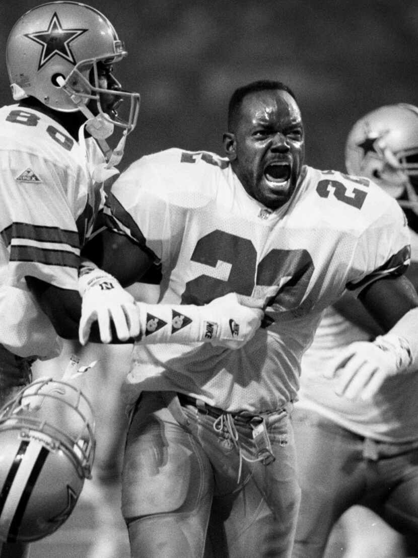 1-30-94--Cowboys RB Emmitt Smith is held  back by WR Michael Irvin as he celebrates a TD run...