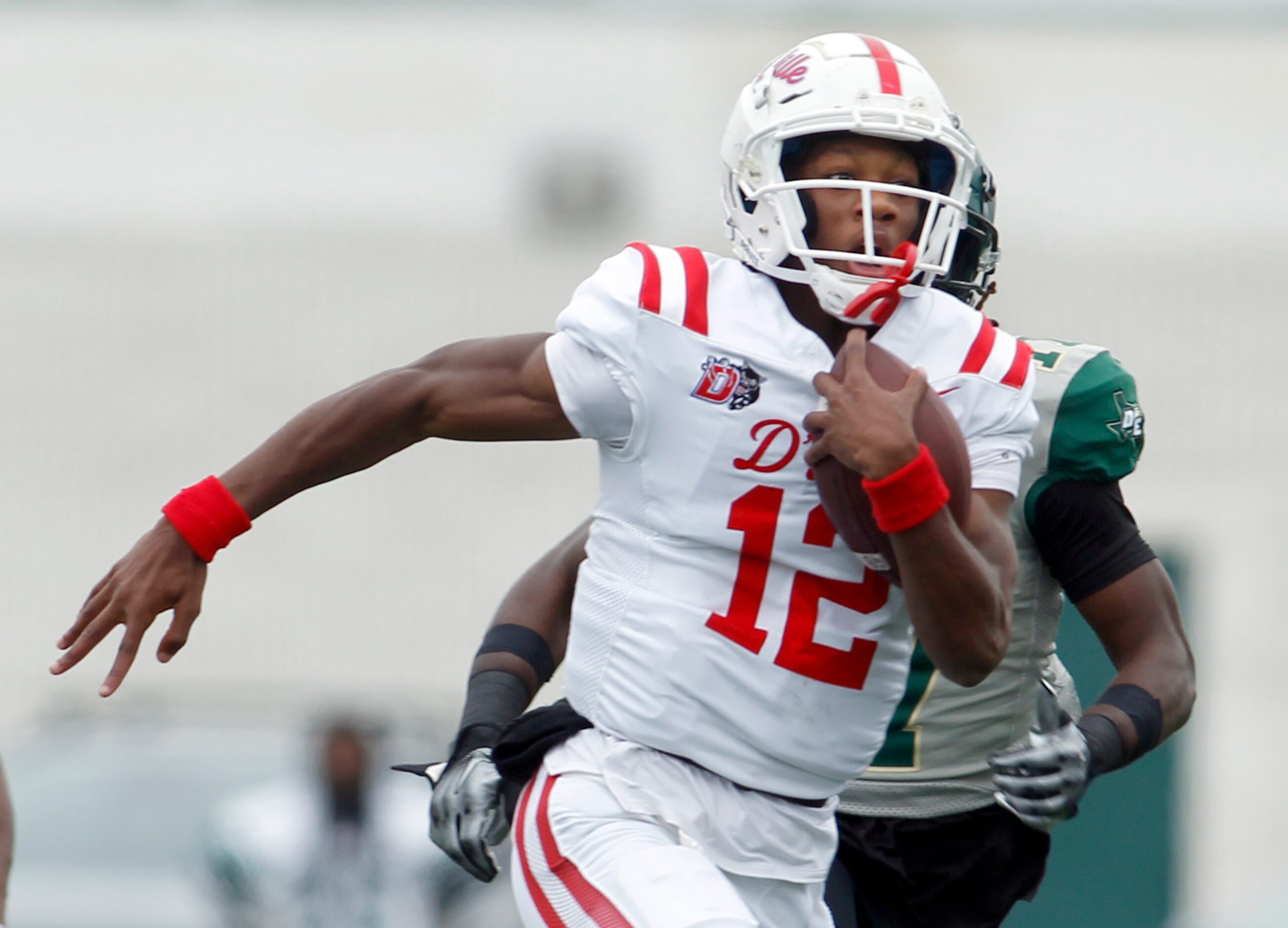 Duncanville quarterback Keelon Russell (12) rambles through the DeSoto secondary for a big...