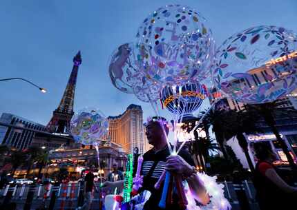 A vendor sells balloons along the Bellagio Fountain on the Las Vegas strip on Saturday.