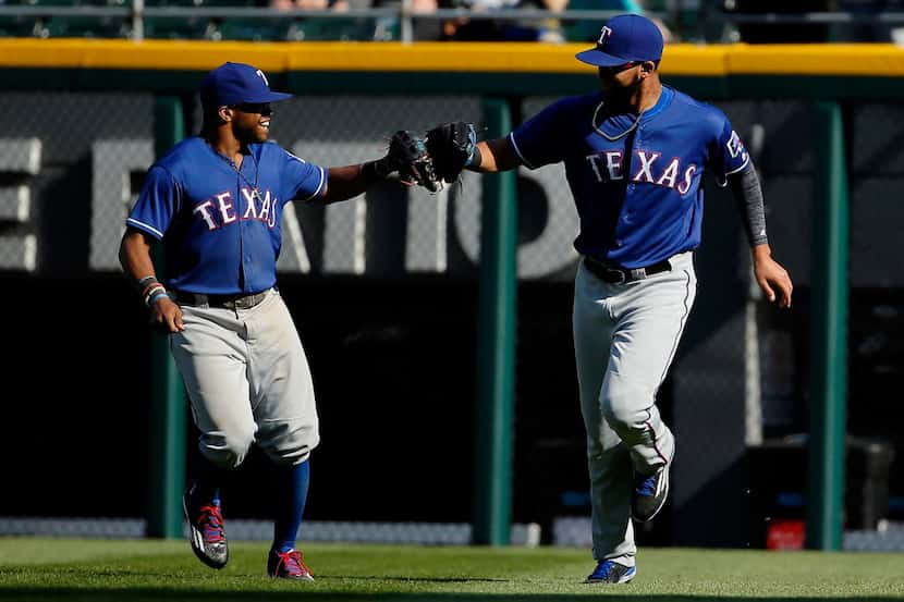 CHICAGO, ILLINOIS - APRIL 23: Nomar Mazara #30 of the Texas Rangers (R) is congratulated by...