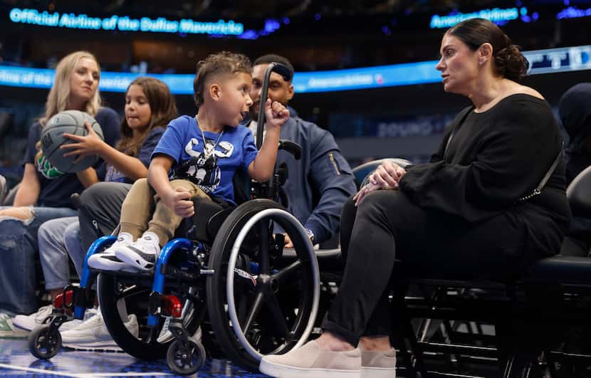 Cash Harris, who suffers from spina bifida, spent time courtside with his family and Marin...