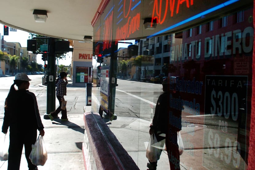 ORG XMIT: *S0410963006* Pedestrians walk by a loan/check cashing shop on University Ave. in...