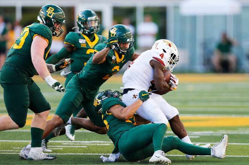 Iowa State Cyclones running back Johnnie Lang (4) is tackled by Baylor Bears linebacker...