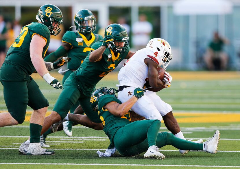 Iowa State Cyclones running back Johnnie Lang (4) is tackled by Baylor Bears linebacker...