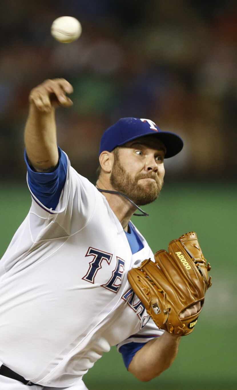 Texas Rangers starting pitcher Colby Lewis (48) pitches in a game against the Detroit Tigers...