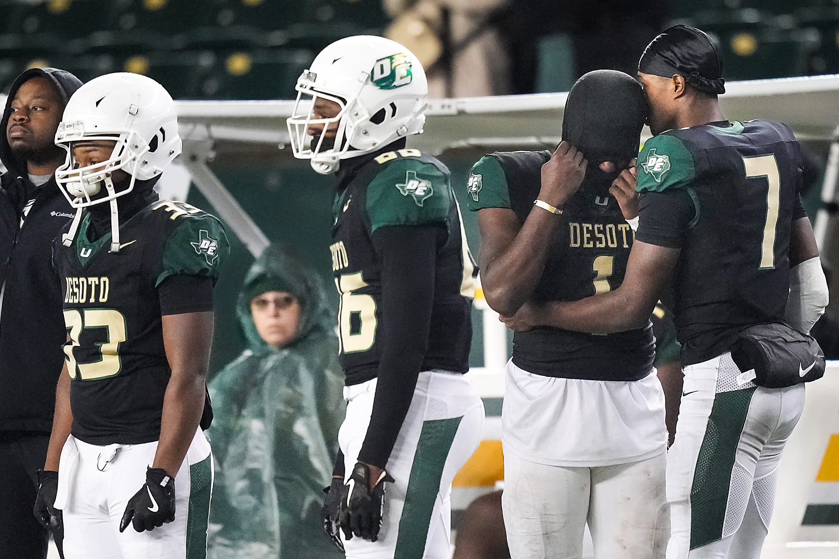 DeSoto running back Deondrae Riden Jr (1) is consoled by wide receiver Ethan Feaster (7) on...