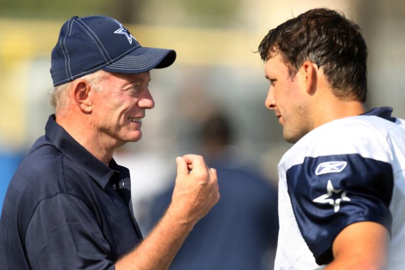 Cowboys owner Jerry Jones talks with quarteback Tony Romo after an afternoon practice no...