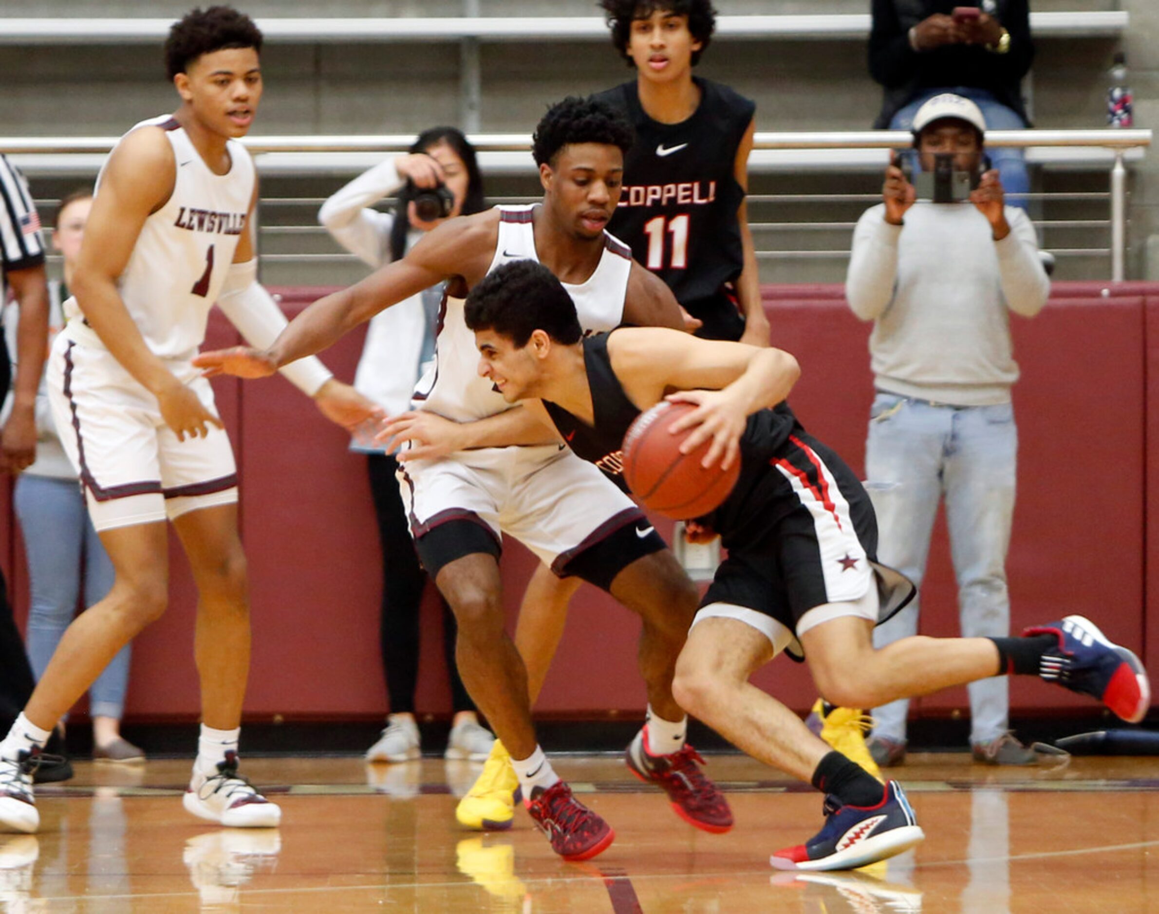 Coppell's Adam Moussa (5) found it challenging to drive the ball past the defense of...