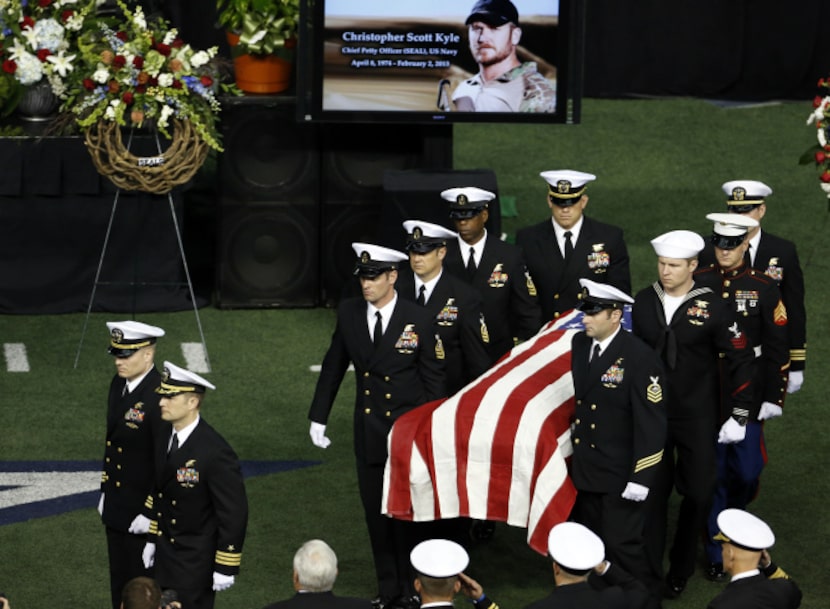 Military members carry the body of former Navy SEAL Chris Kyle after the memorial service on...