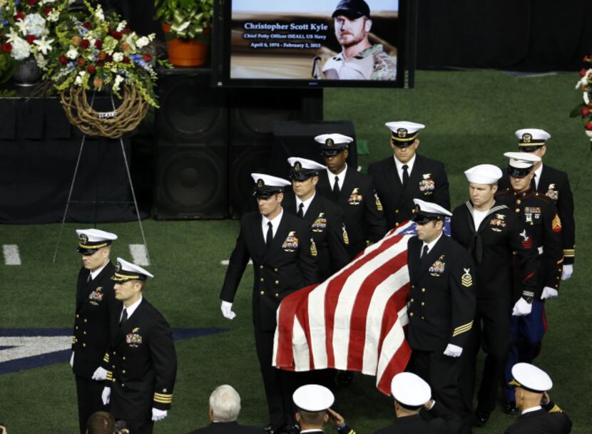 Military members carry the body of former Navy SEAL Chris Kyle after the memorial service on...