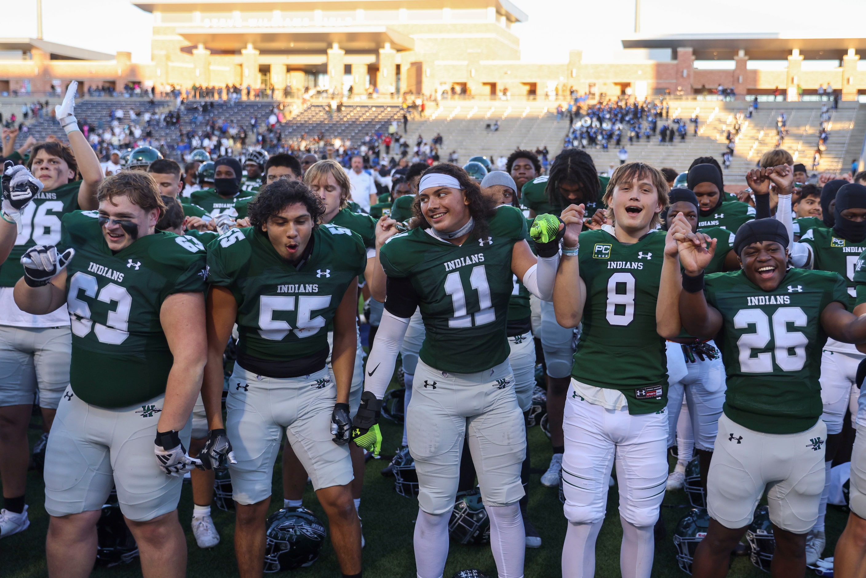 Waxahachie High players sing the school anthem following their win against North Forney  in...