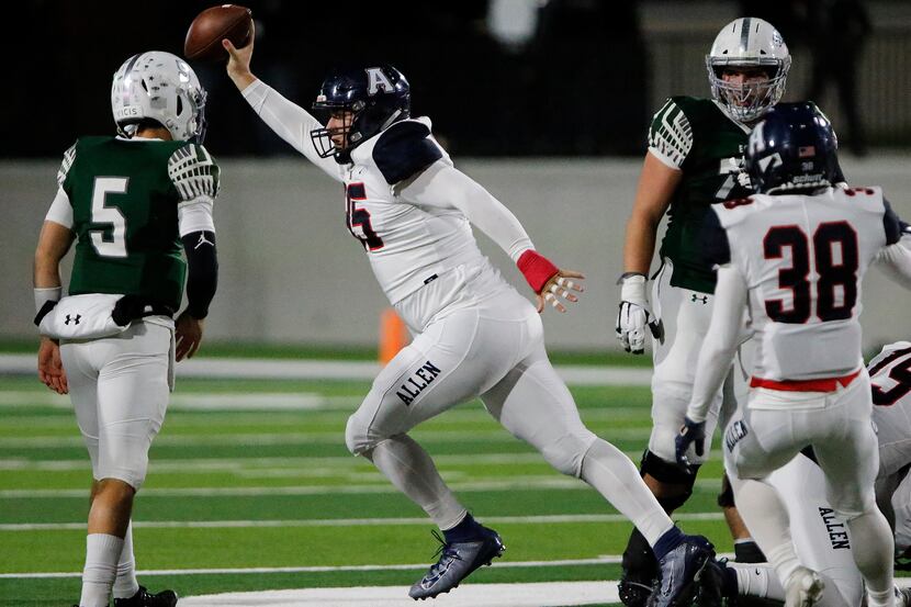 Allen High School defensive lineman Elijah Fisher (95) emerges with a fumble recovery during...