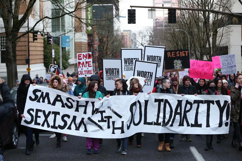People march in support of female empowerment and women's rights Jan. 20, 2018, in Portland,...