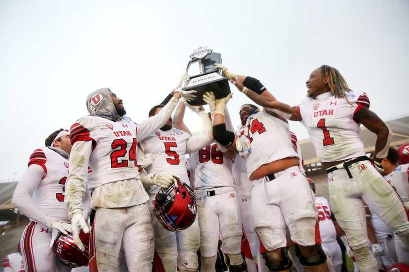 Utah Utes hold up their championship trophy after winning Zaxby's Heart of Dallas Bowl...