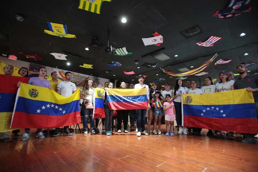 Venezuelans gathered at Las Palmas Restaurant sing the Venezuelan national on April 30, 2019.