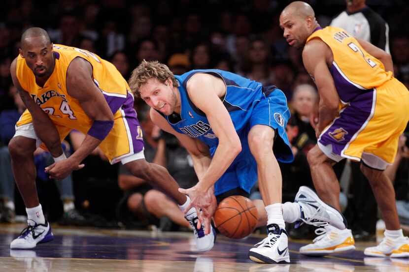 Dallas Mavericks' Dirk Nowitzki, of Germany, loses the ball as Los Angeles Lakers' Kobe...