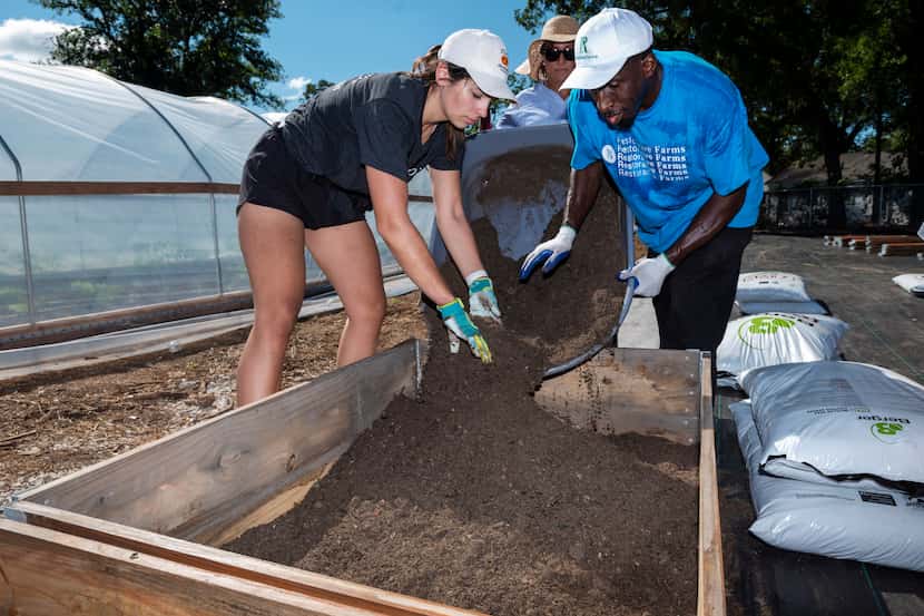 Shelby Espinosa and Charles Spencer filled a GroBox with soil during the expansion of the...