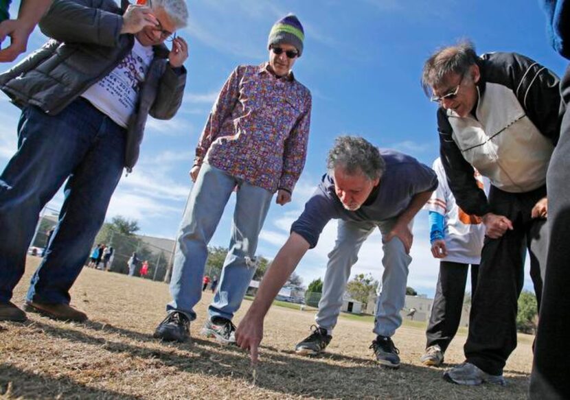 
Quarterback Billy Jacobs drew a play in the dirt during a huddle. 


