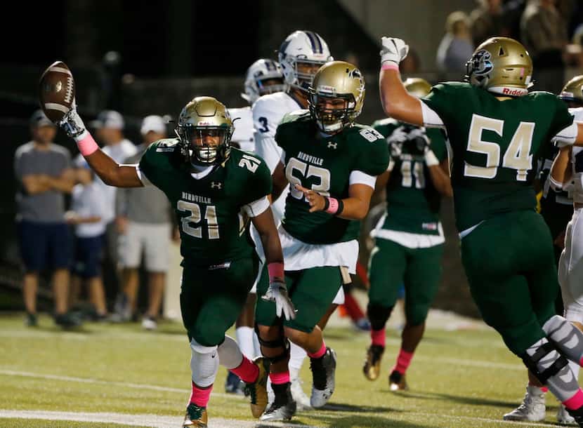 Birdville's Laderrious Mixon (21) celebrates his first rushing touchdown against Richland...