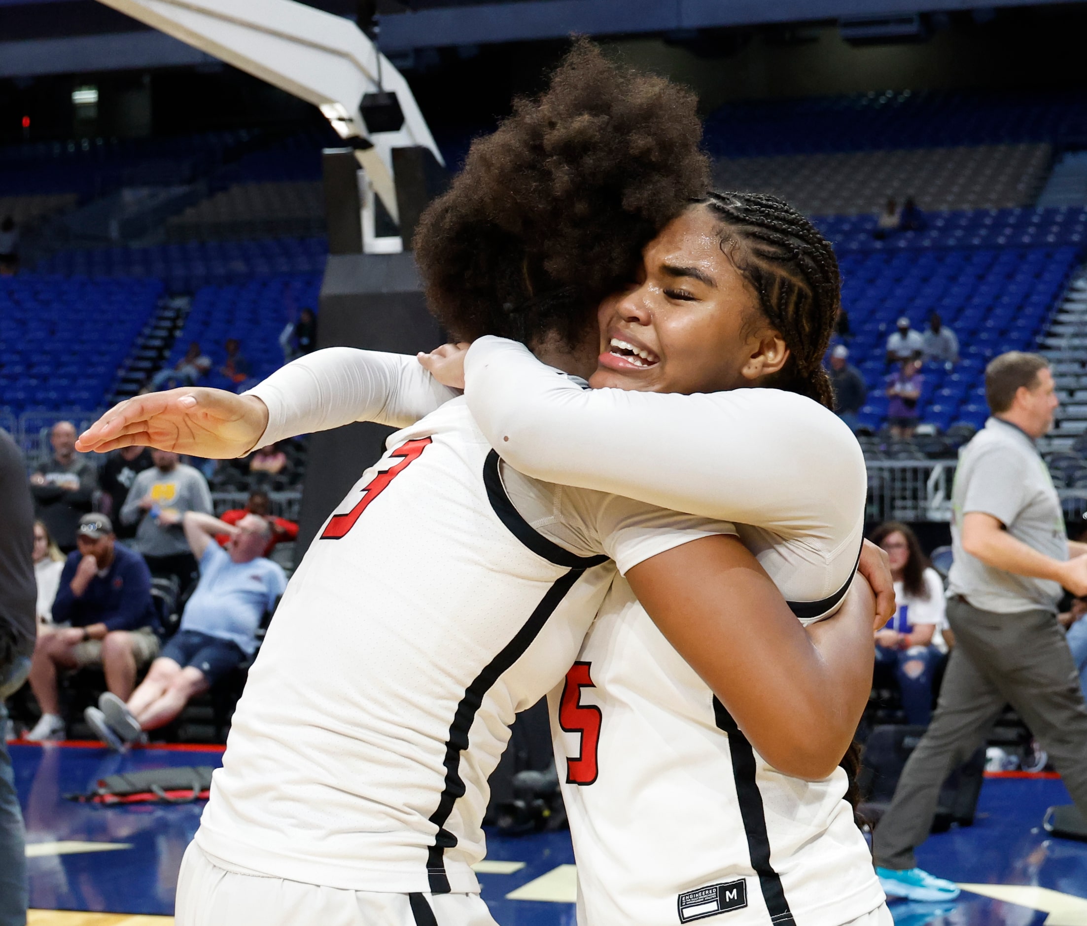 Frisco Liberty's Jacy Abii (3) is hugged by teammate Keyera Roseby (5) after winning the UIL...