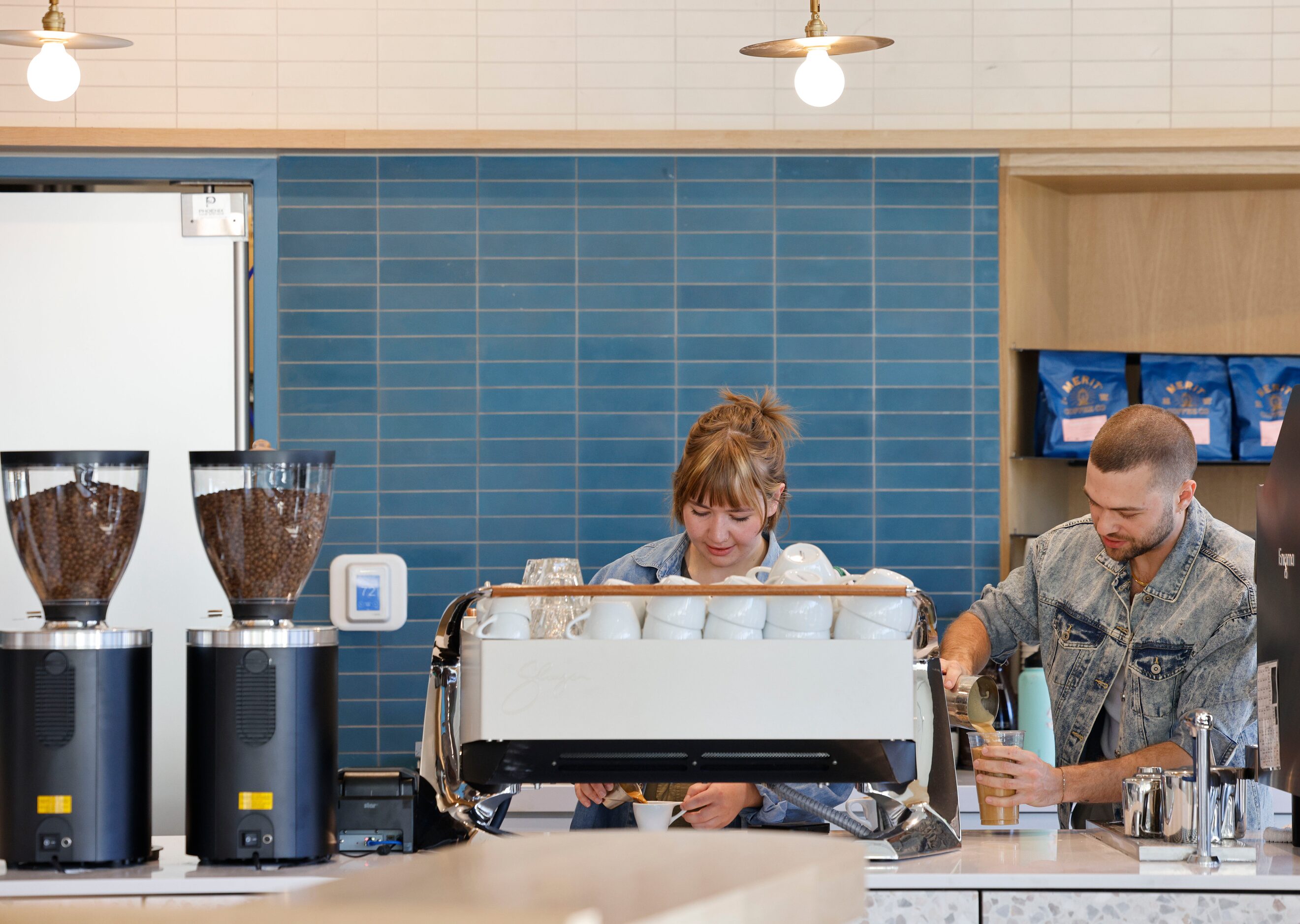 Dorothy Bartke, assistant cafe manager, and Artem Veksha, cafe manager, work during a soft...