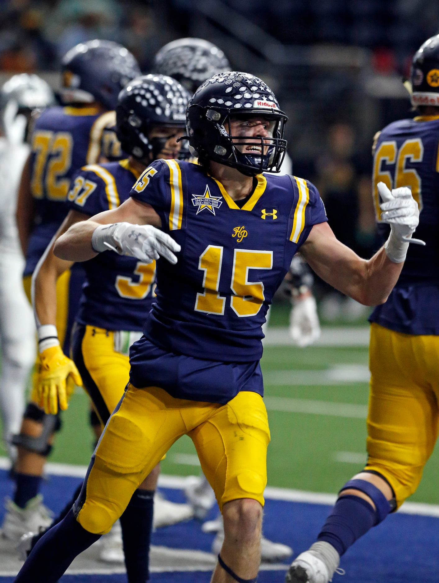 Highland Park High’s Benton Owens (15) celebrates his touchdown during the first half of a...