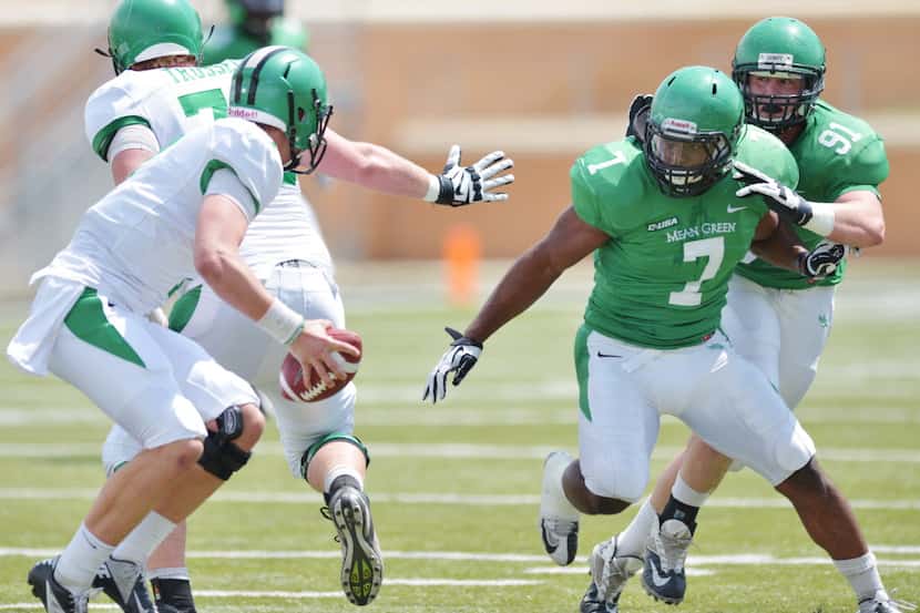University of North Texas linebacker Derek Akunne (7) closes in on quarterback Connor Means...