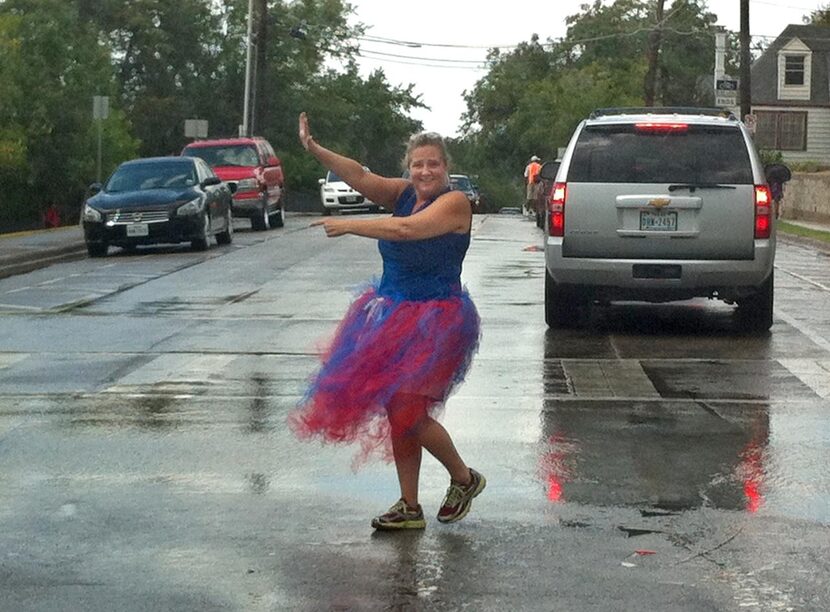 
Rosemont Principal Anna Brining, in a tutu, directs traffic near the school.
