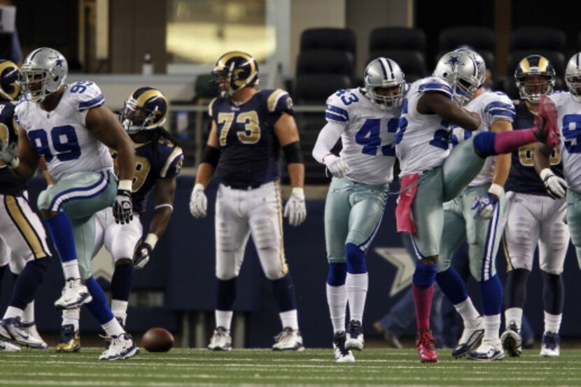 Dallas Cowboys strong safety Abram Elam (26) and the Cowboys defense celebrates a 4th down...