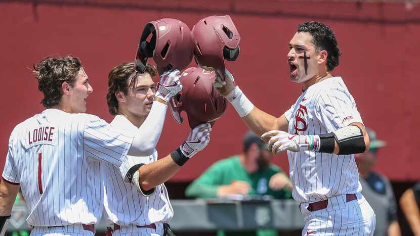 Florida State's Daniel Cantu, right, celebrates his solo home run with Alex Lodise (1), and...