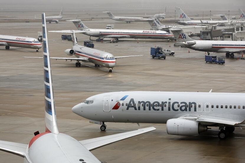  American Airlines jets maneuver around American's terminals at Dallas/Fort Worth...