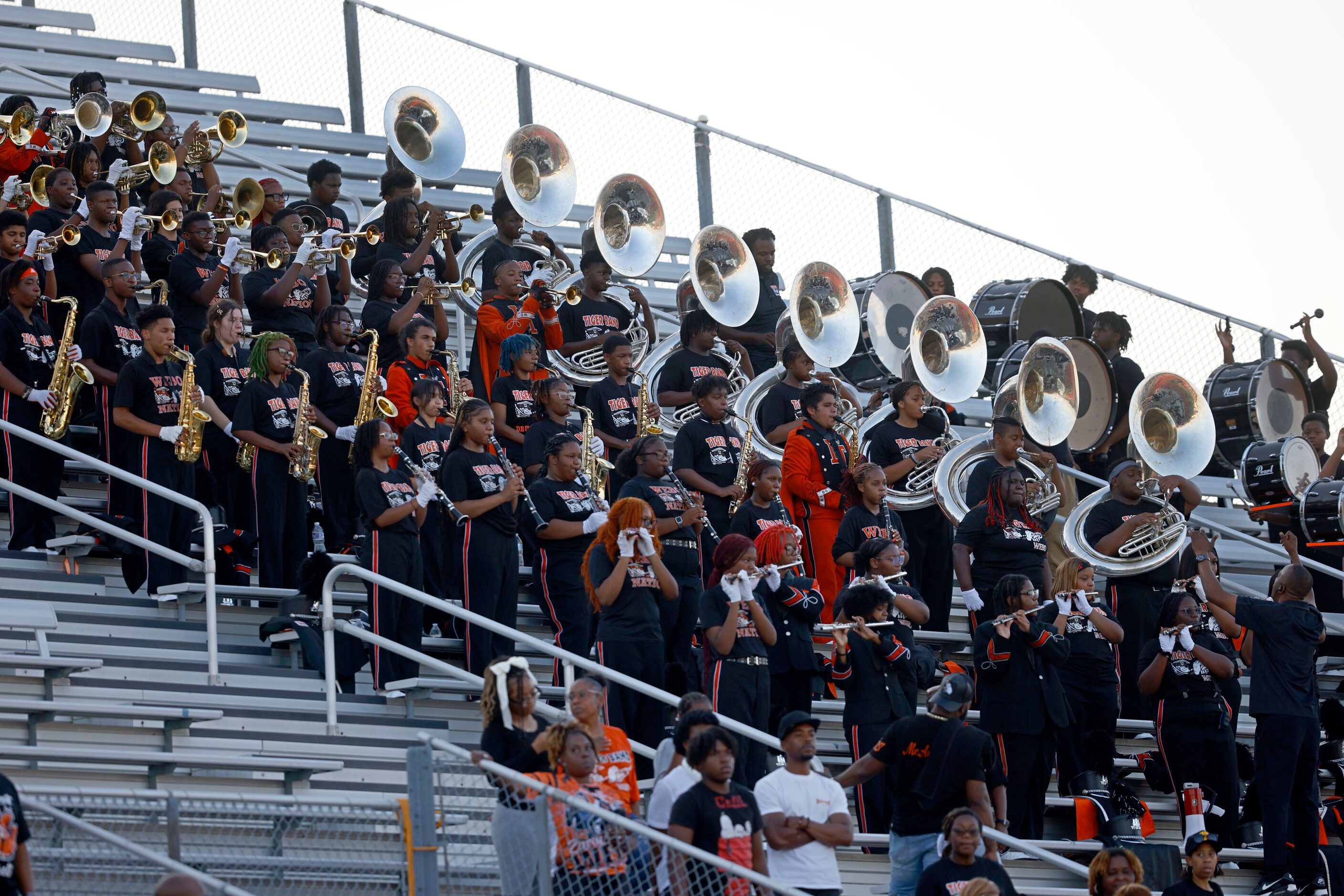 Lancaster’s marching band members perform before a high school football game against...