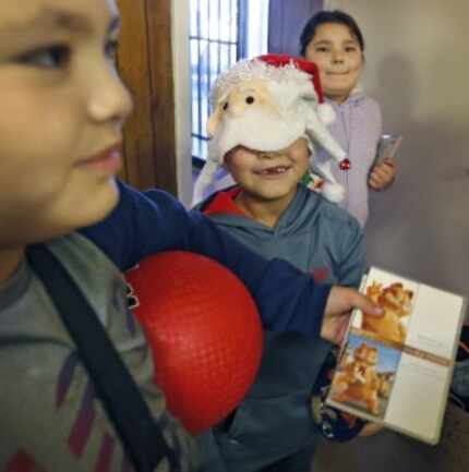  "I'm Santa!" giggled Michael Santillano, 7, as he donned a festive hat alongside his...