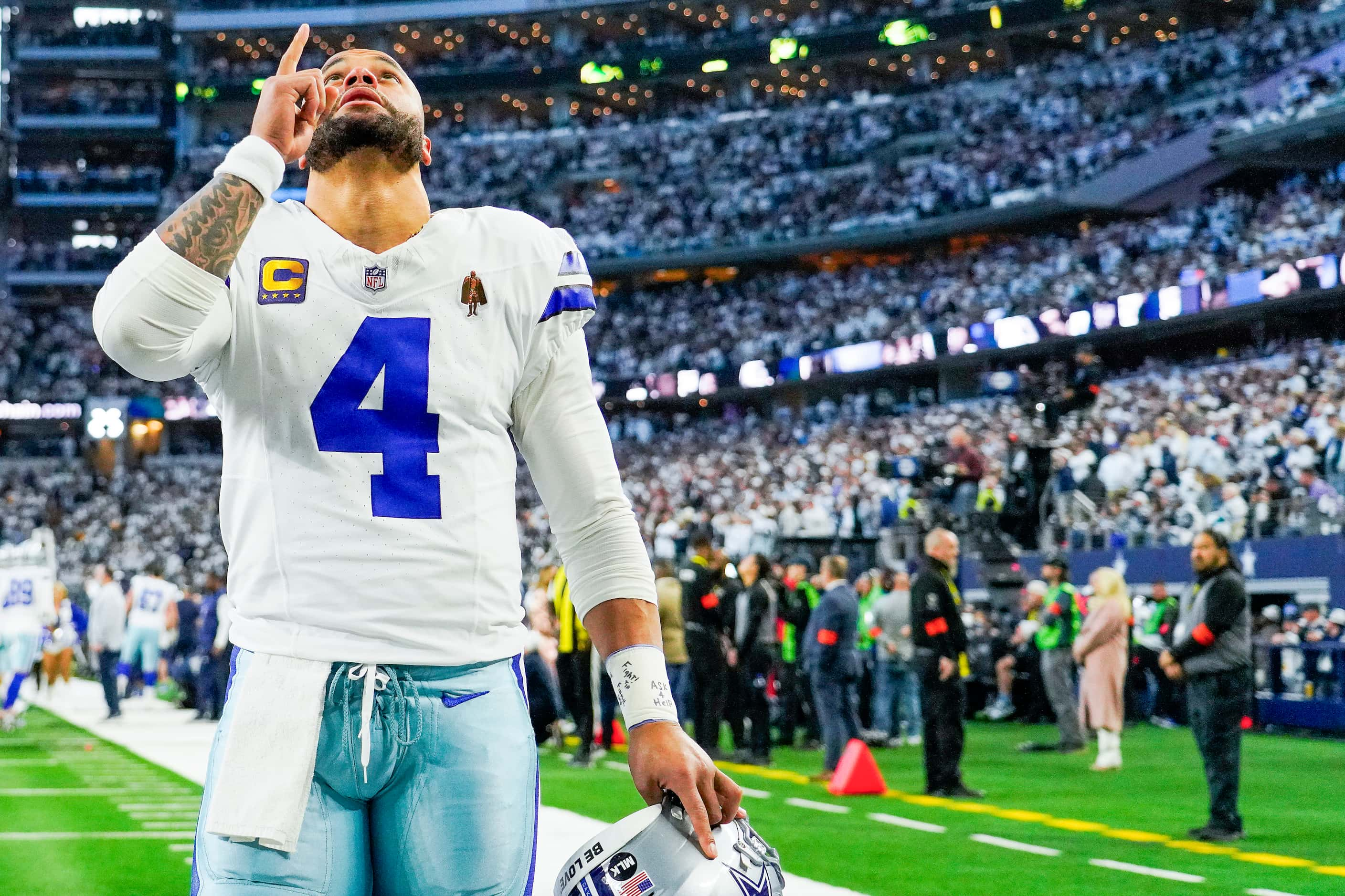 Dallas Cowboys quarterback Dak Prescott (4) points upward after taking the field for an NFL...