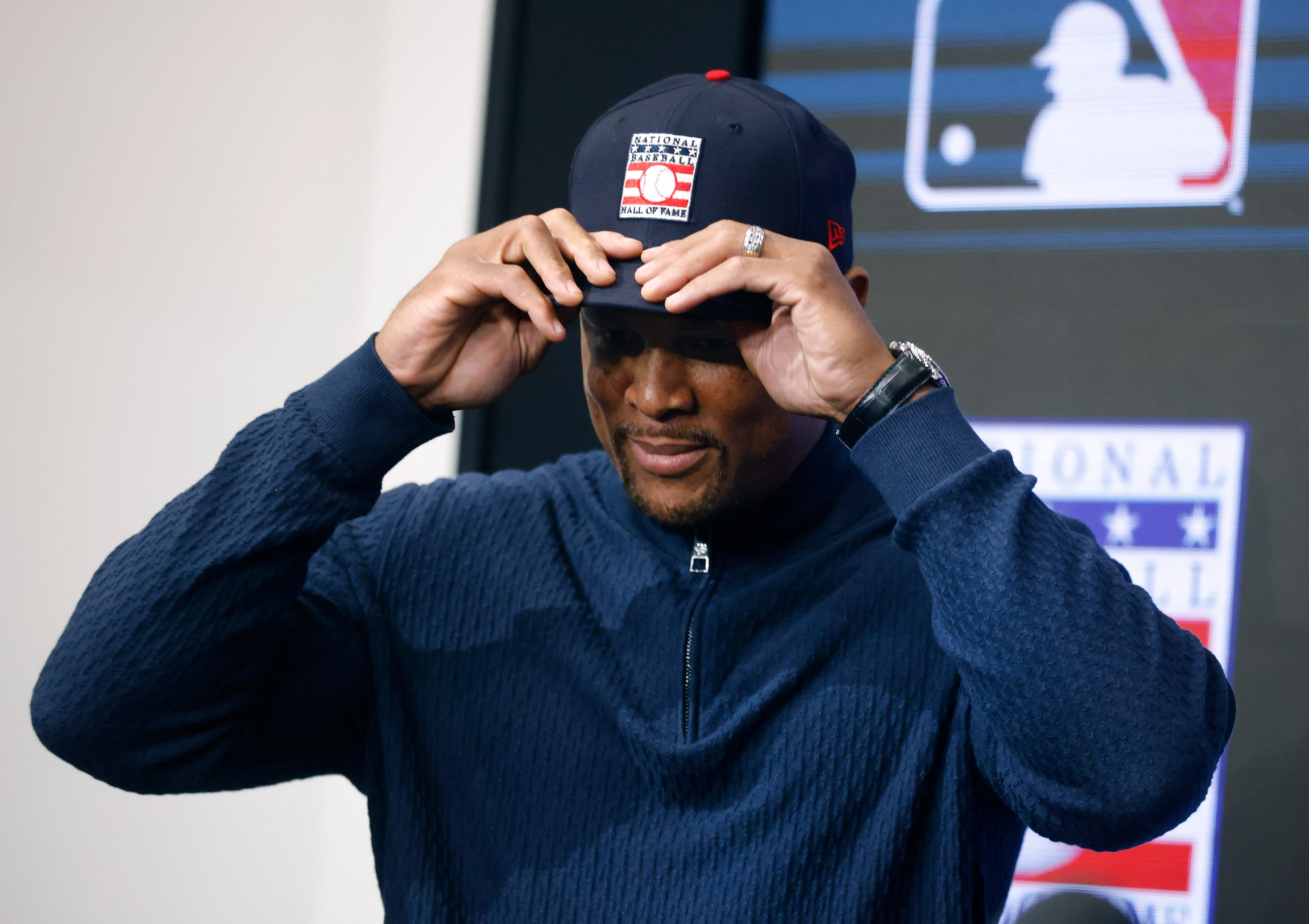 Former Texas Rangers third baseman Adrián Beltré tries on his new Hall of Fame cap given to...