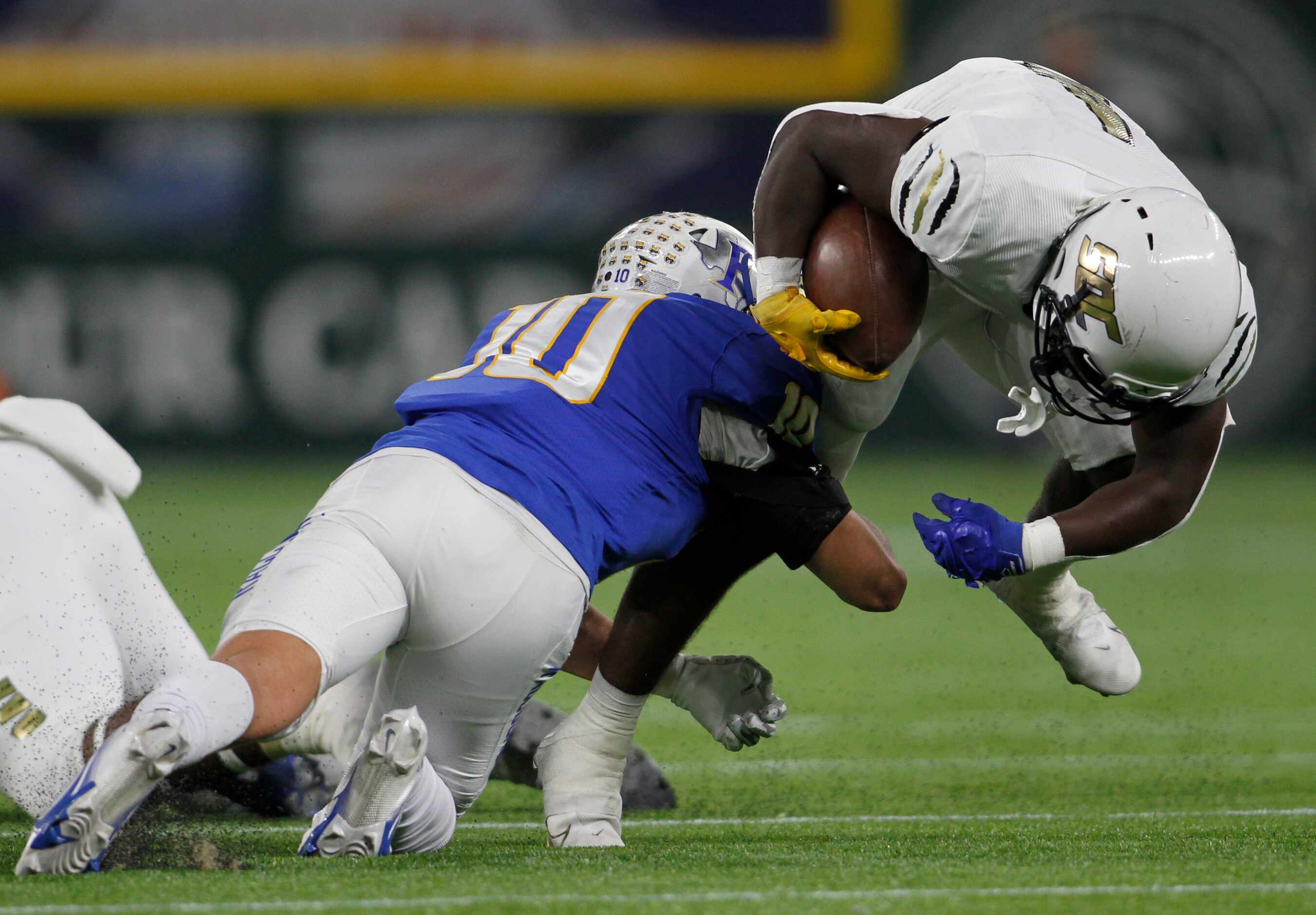 South Oak Cliff running back Qualon Farrar (4), right, is unable to elude the tackle of...